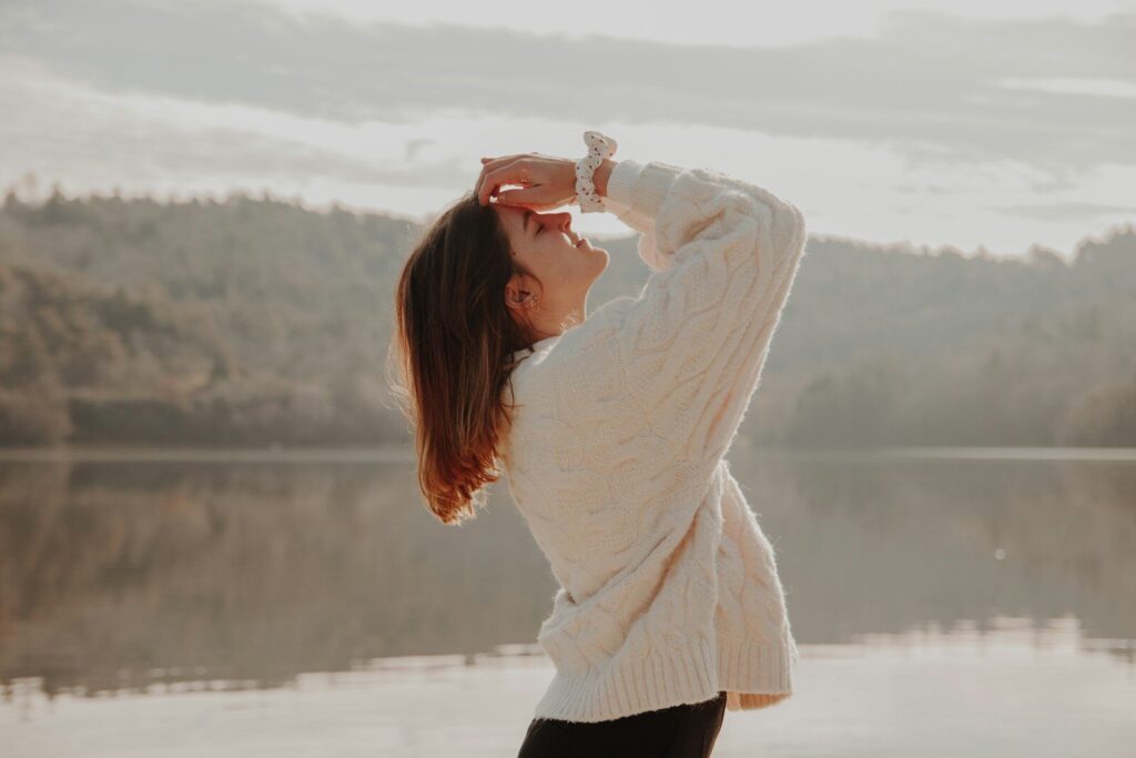 woman in white sweater and black skirt standing on snow covered ground during daytime