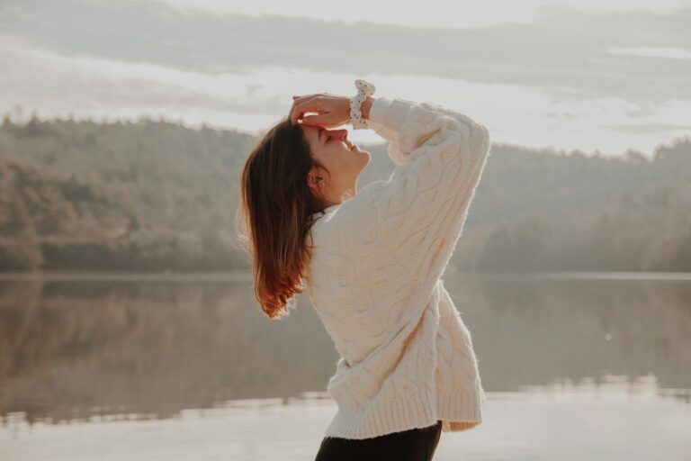 woman in white sweater and black skirt standing on snow covered ground during daytime
